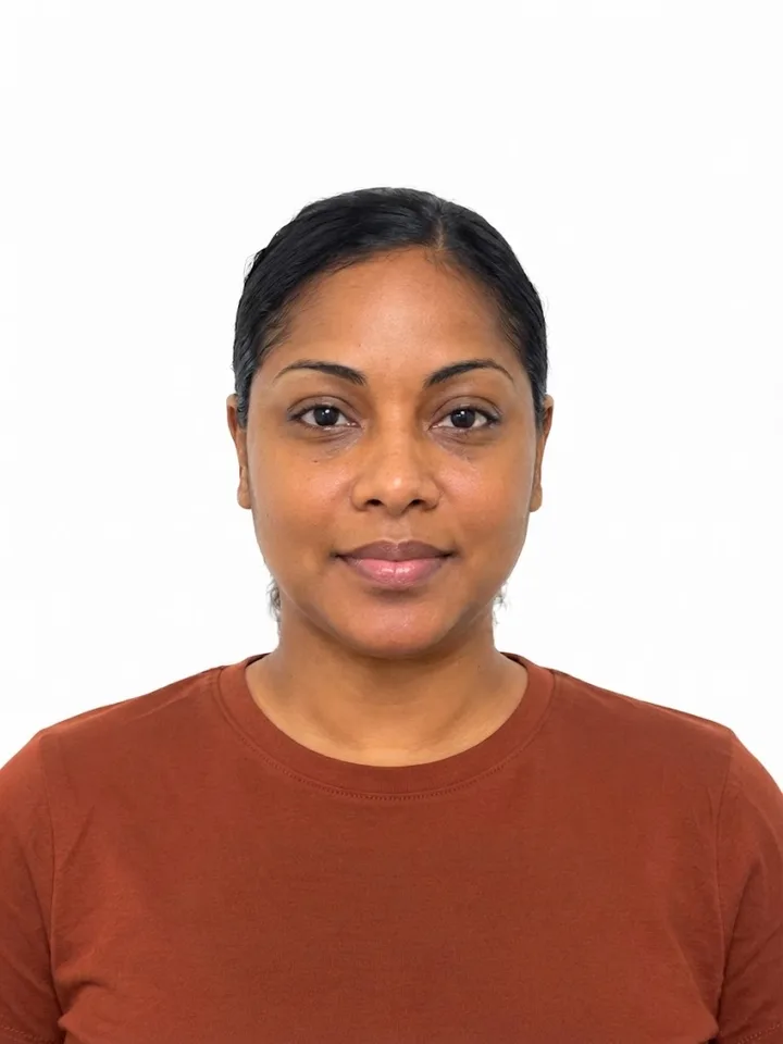Sample phone photo of a woman in a rust-coloured t-shirt, taken from mid-chest up against a plain white wall