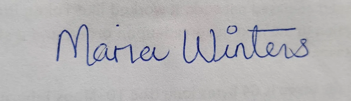 Sample signature in blue pen on paper, photographed with a phone